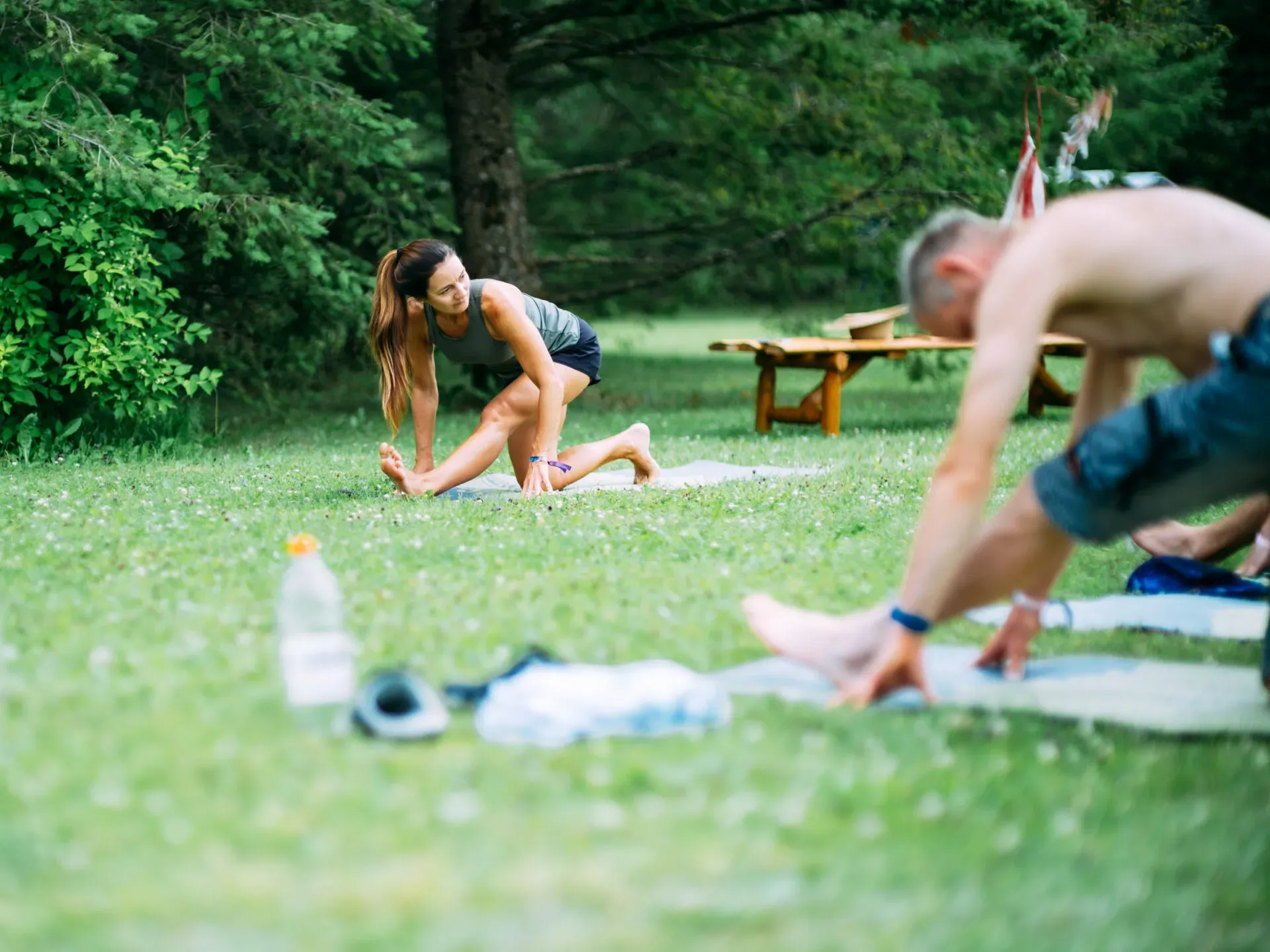 Morning yoga on the grass between the trees