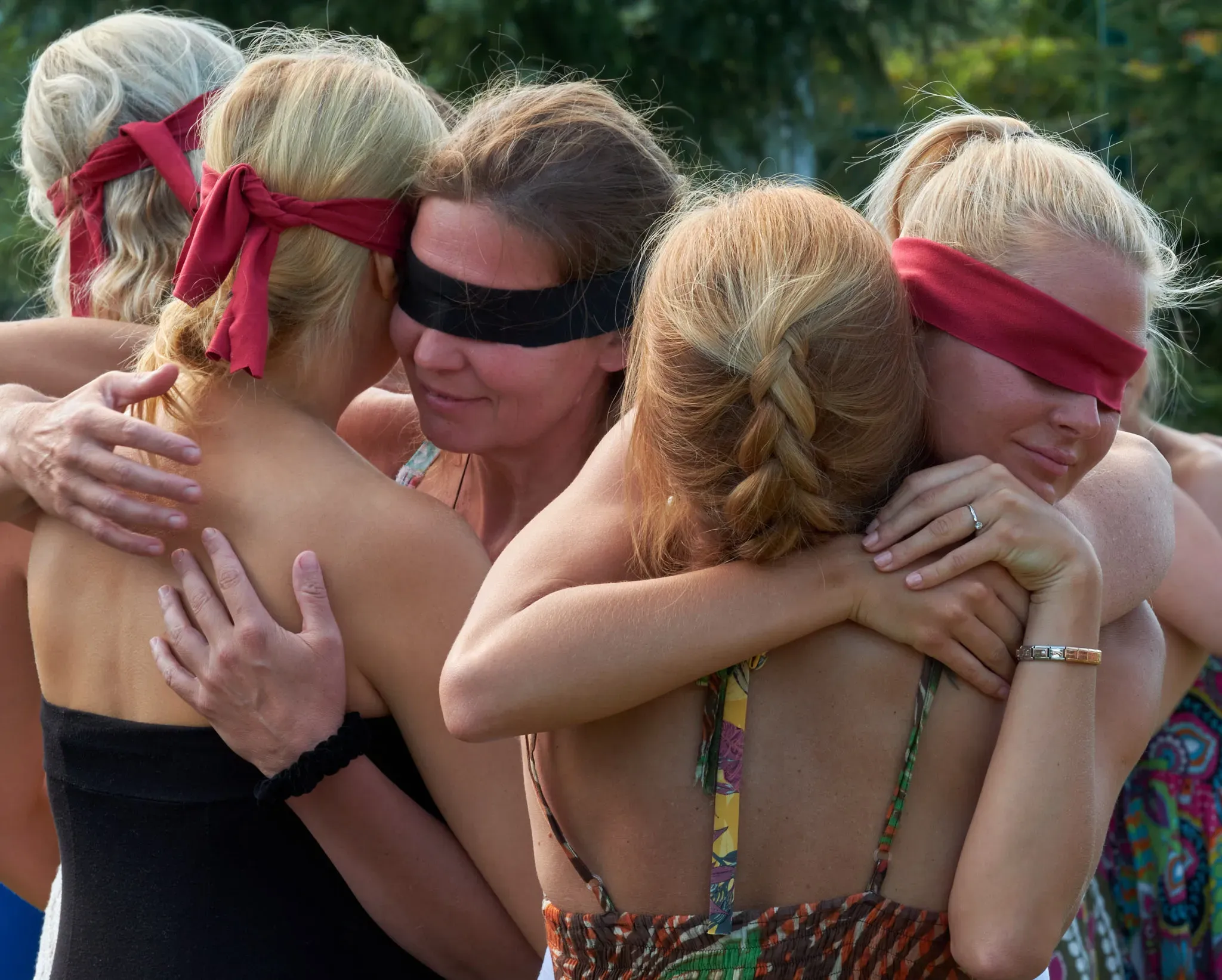 A blindfolded trust exercise in the summer sun