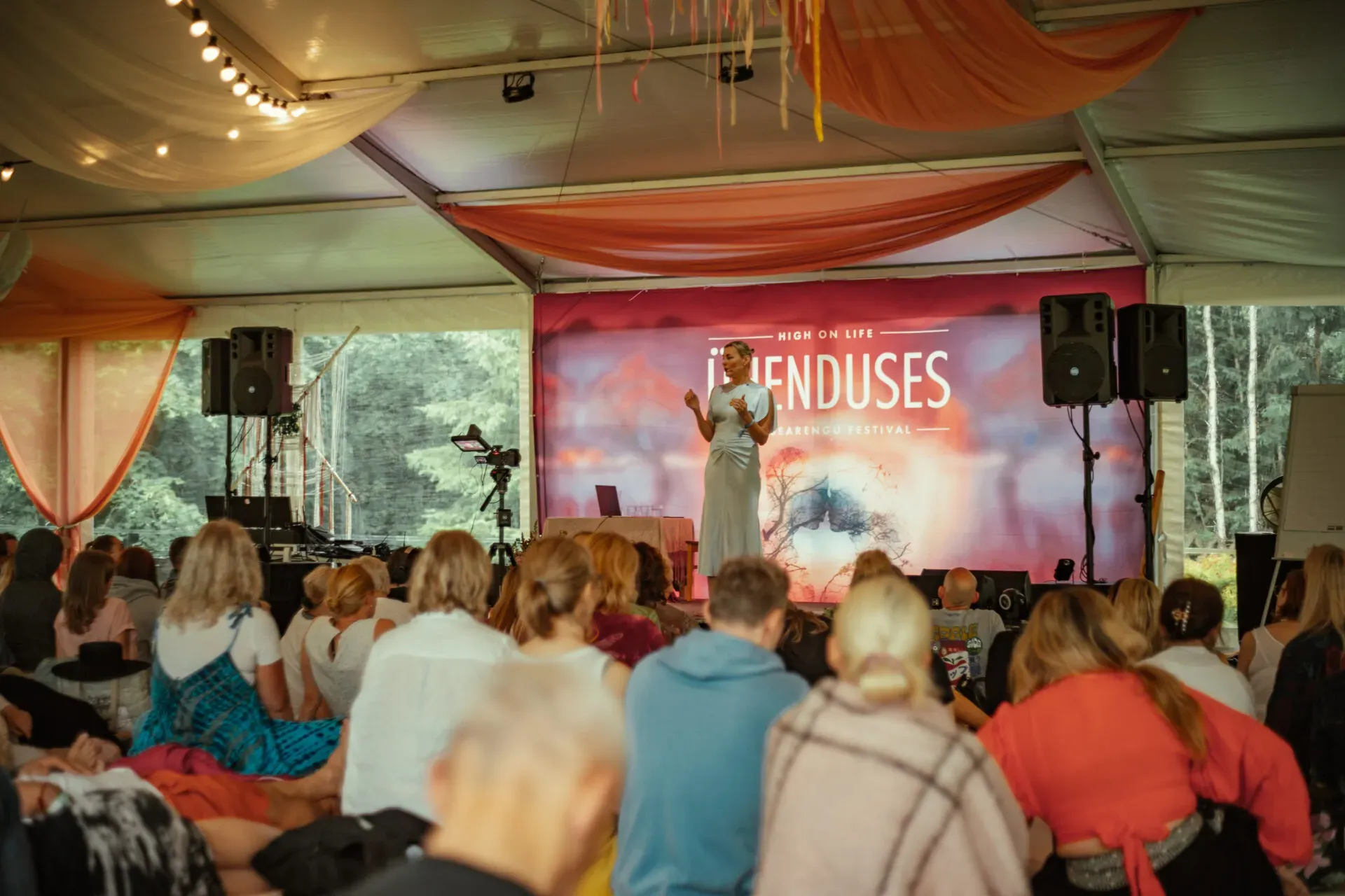 A speaker on the festival main stage in the big tent